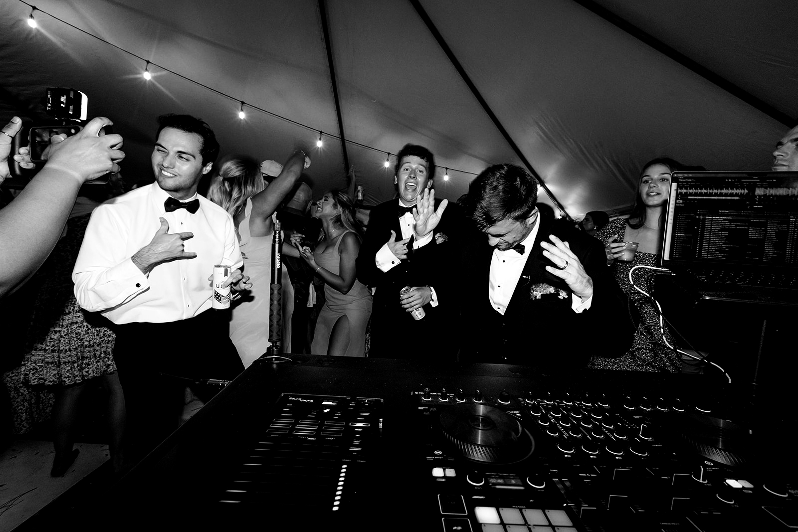 DJ mixing at a packed tented wedding reception